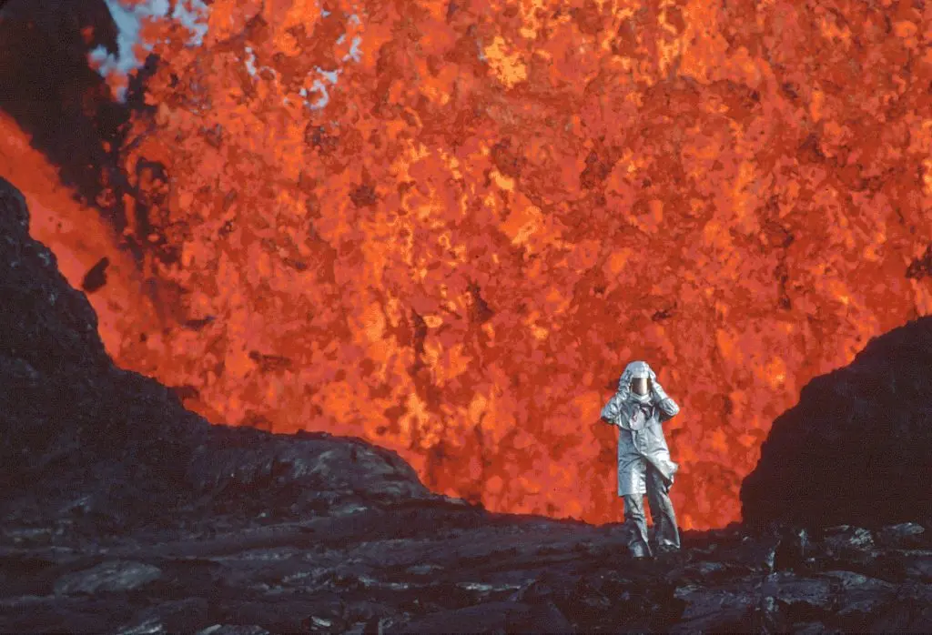 Katia Krafft wearing aluminized suit standing near lava burst at Krafla Volcano, Iceland. (Credit: Image'Est)