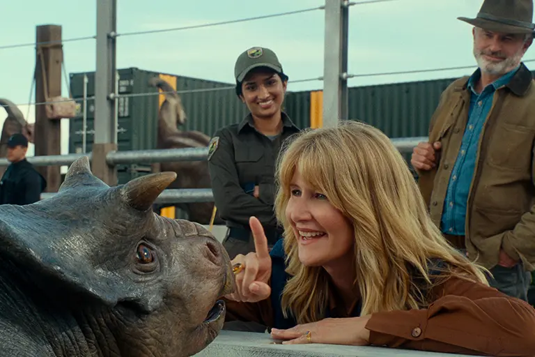 (from left) A baby Nasutoceratops, Dr. Ellie Sattler (Laura Dern) and Dr. Alan Grant (Sam Neill) in Jurassic World Dominion, co-written and directed by Colin Trevorrow - \\u00A9 2022 Universal Studios and Amblin Entertainment. All Rights Reserved