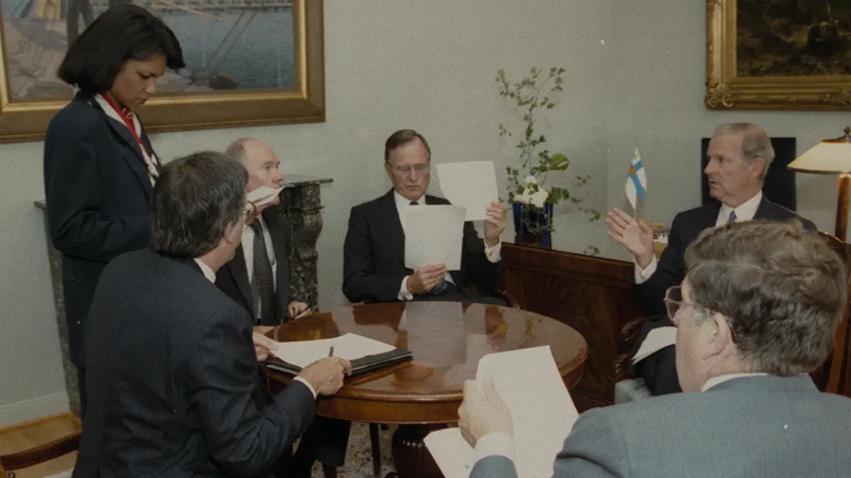 Turning Point: The Bomb and the Cold War. Condoleezza Rice (L) and President George H. W. Bush (center). Cr. Courtesy of Netflix