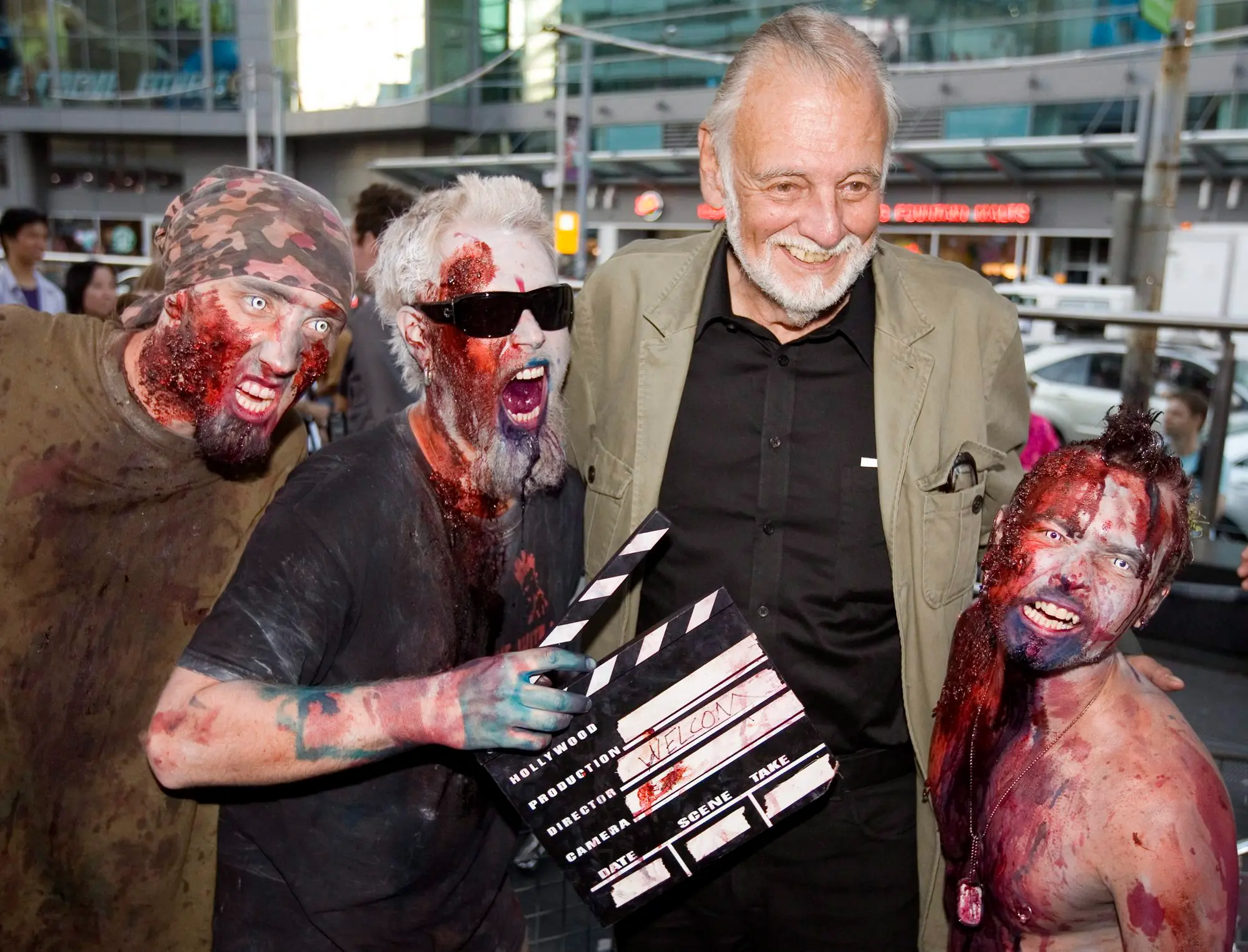 George Romero con alcuni fan vestiti da zombi