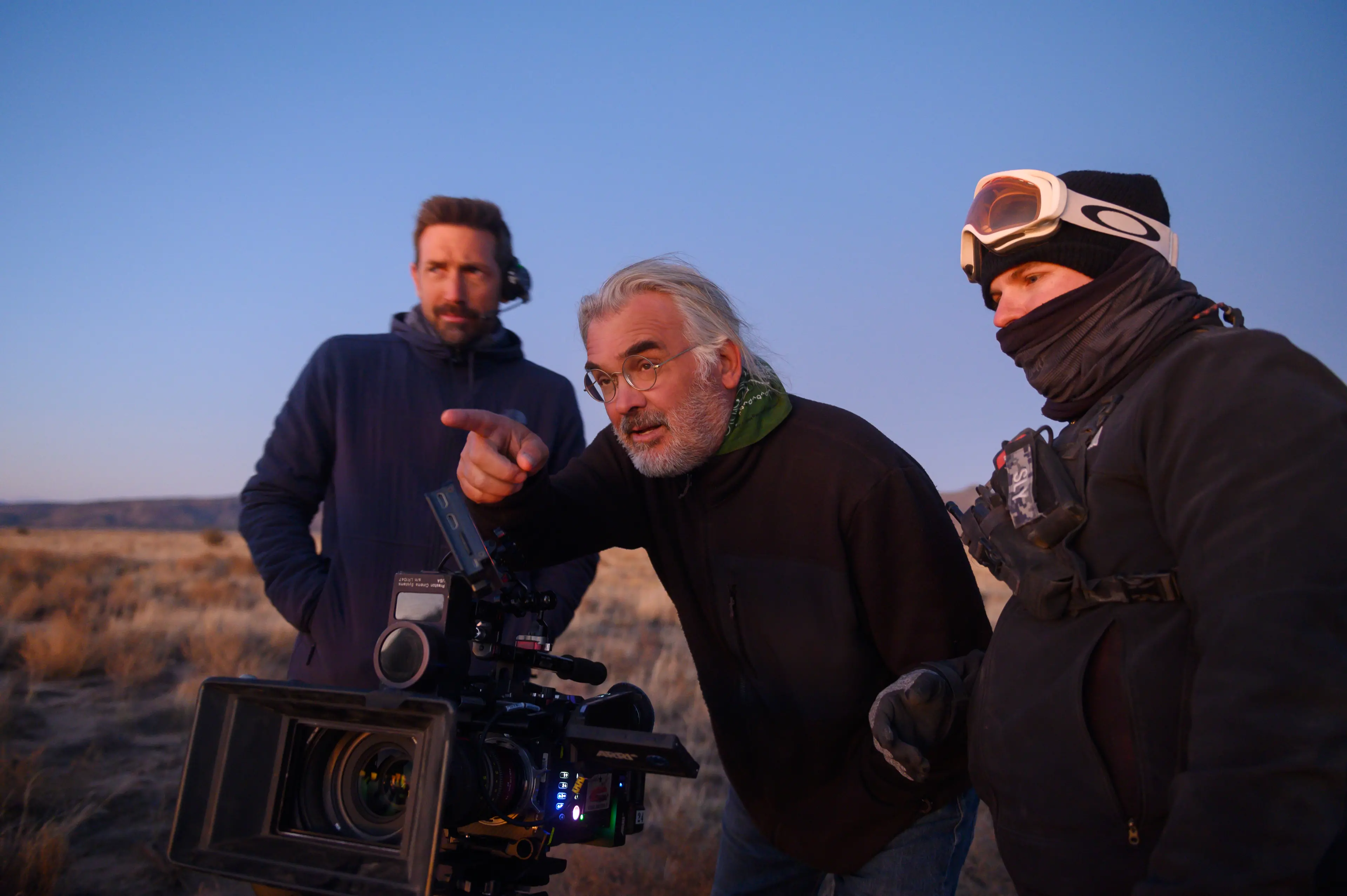 Director and co-writer Paul Greengrass (center) with crew members on the set of News of the World - Photo Credit: Bruce W. Talamon/Universal Pictures/Netflix