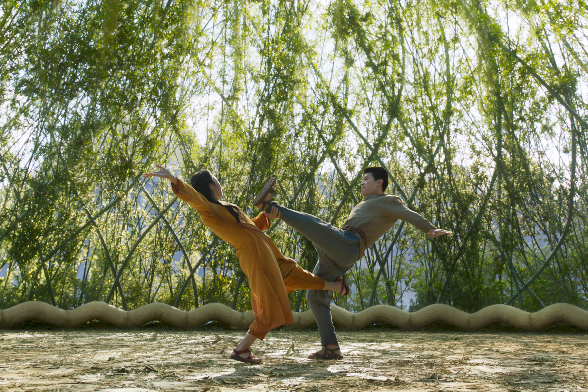 (L-R): Ying Nan (Michelle Yeoh) and Shang-Chi (Simu Liu) in Marvel Studios' SHANG-CHI AND THE LEGEND OF THE TEN RINGS. Photo courtesy of Marvel Studios. ©Marvel Studios 2021. All Rights Reserved.