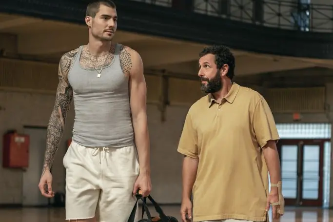 HUSTLE. (L-R) Juancho Hernangomez as Bo Cruz and Adam Sandler as Stanley Sugerman in Hustle. Cr. Cassy Athena/Netflix © 2022.