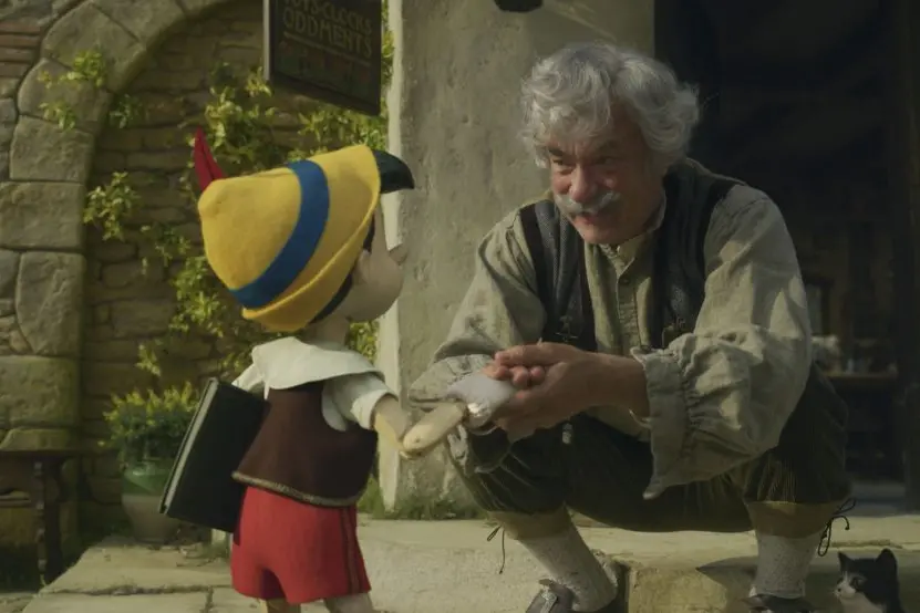 (L-R): Pinocchio (voiced by Benjamin Evan Ainsworth), Tom Hanks as Geppetto, and Figaro in Disney's live-action PINOCCHIO, exclusively on Disney+. Photo courtesy of Disney Enterprises, Inc. © 2022 Disney Enterprises, Inc. All Rights Reserved.